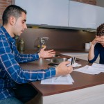 Desperate couple reviewing their credit card debts