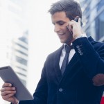 Businessman using a mobile phone and digital tablet