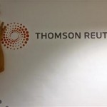 Contractors install Thomson Reuters signage at the Reuters office in downtown